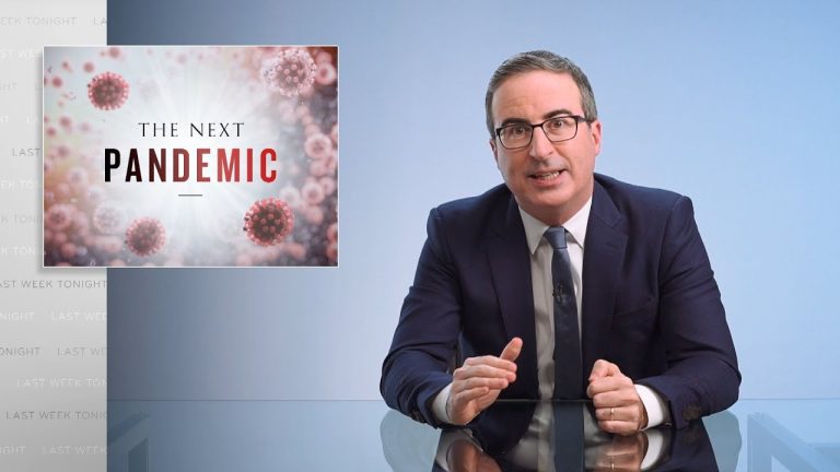 John Oliver at the Last Week Tonight desk beside a screen reading “The Next Pandemic.” Credit: Last Week Tonight with John Oliver / HBO.
